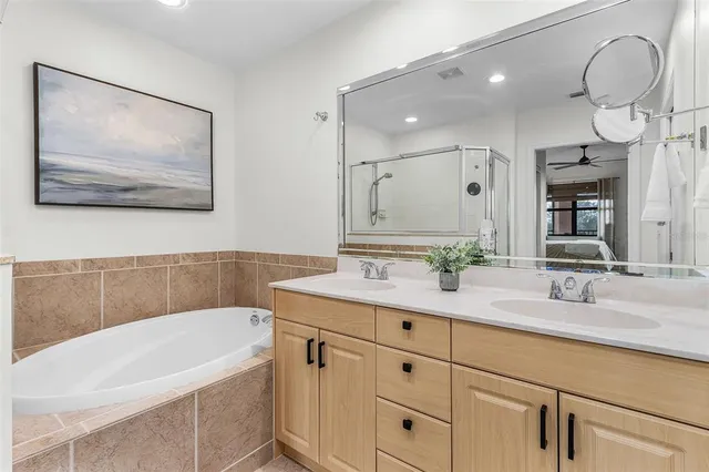 a bathroom with a sink a vanity and a bathtub