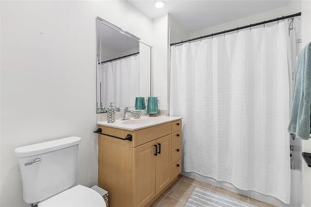 a view of a livingroom with a couch and a ceiling fan