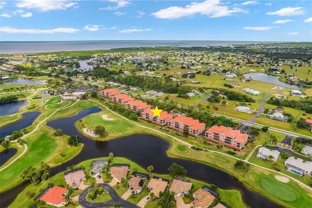 an aerial view of residential houses with outdoor space and river