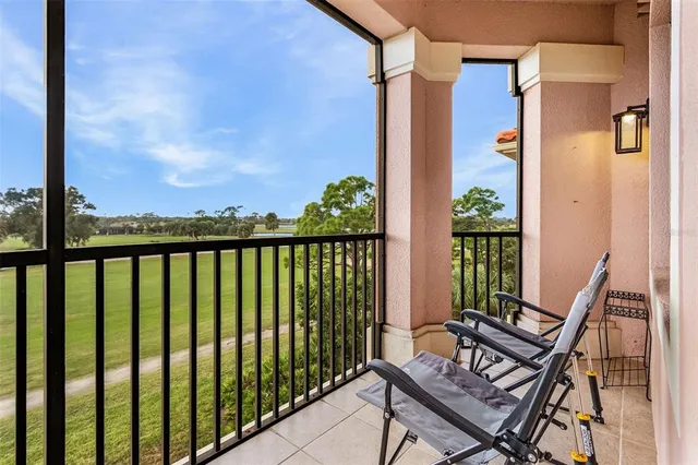 a view of a balcony with chair and wooden floor