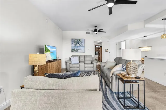 a living room with furniture and a ceiling fan
