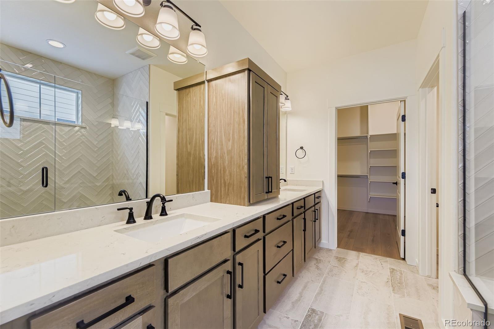 8942 South Riviera Way Aurora, CO 80016 - Photo 15 of 29 a bathroom with a double vanity sink and a mirror