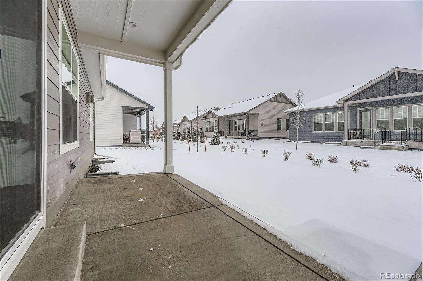 8942 South Riviera Way Aurora, CO 80016 - Photo 26 of 29 a view of a house with snow on the road