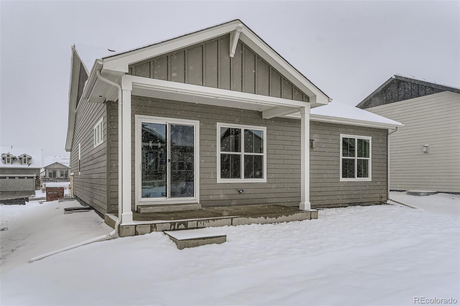 8942 South Riviera Way Aurora, CO 80016 - Photo 28 of 29 a front view of a house with a garage