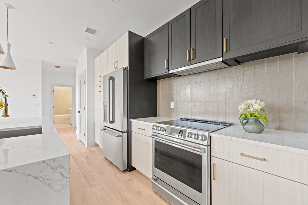 a kitchen with a stove and a refrigerator