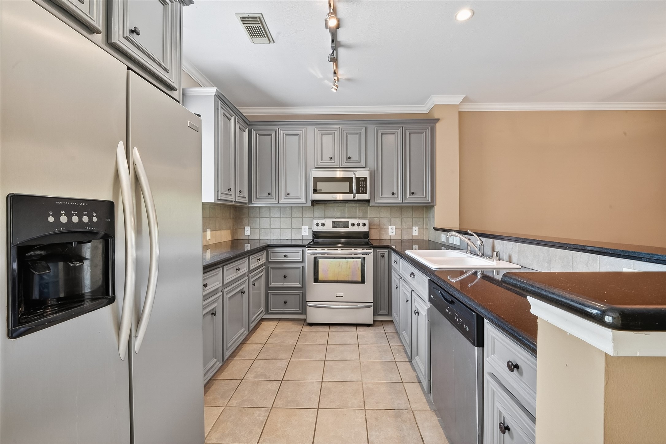 2804 Chenevert Street Houston, TX 77004 - Photo 15 of 37 a kitchen with stainless steel appliances granite countertop a stove a sink and a refrigerator