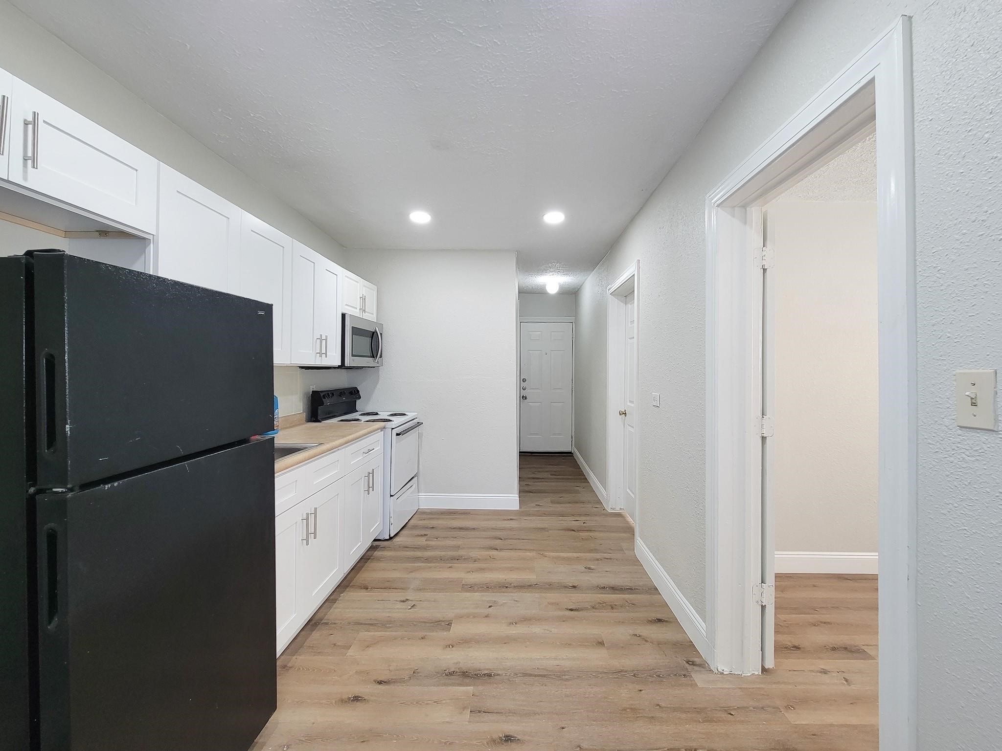 711 Ave A, Unit 1 La Marque, TX 77568 - Photo 15 of 18 a kitchen with stainless steel appliances a refrigerator and a stove top oven