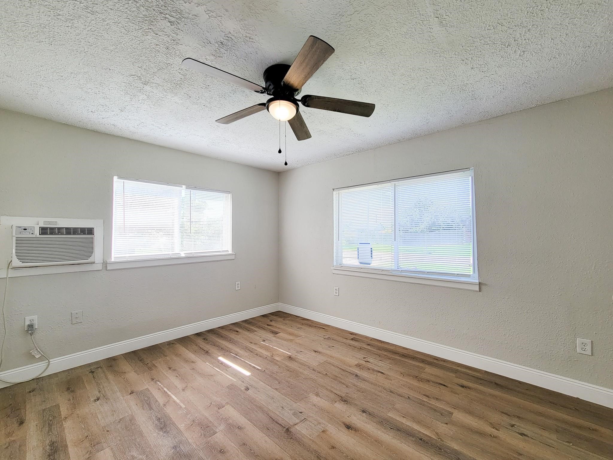 711 Ave A, Unit 1 La Marque, TX 77568 - Photo 4 of 18 a view of an empty room with wooden floor and a window