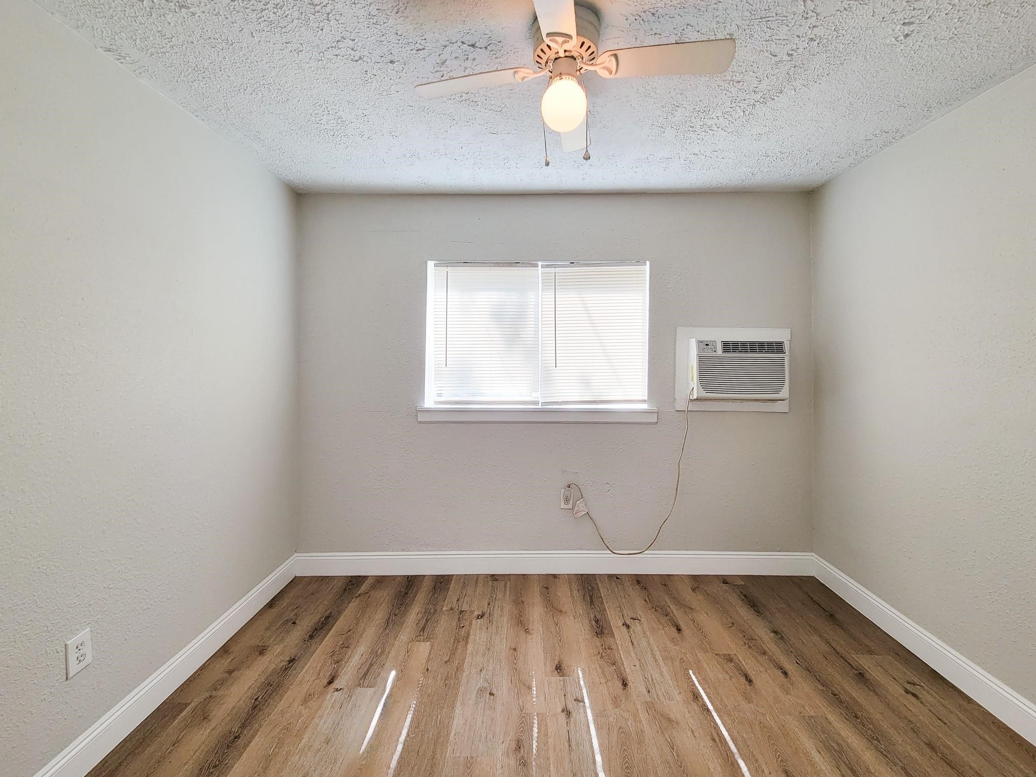 711 Ave A, Unit 1 La Marque, TX 77568 - Photo 6 of 18 wooden floor in an empty room with a window