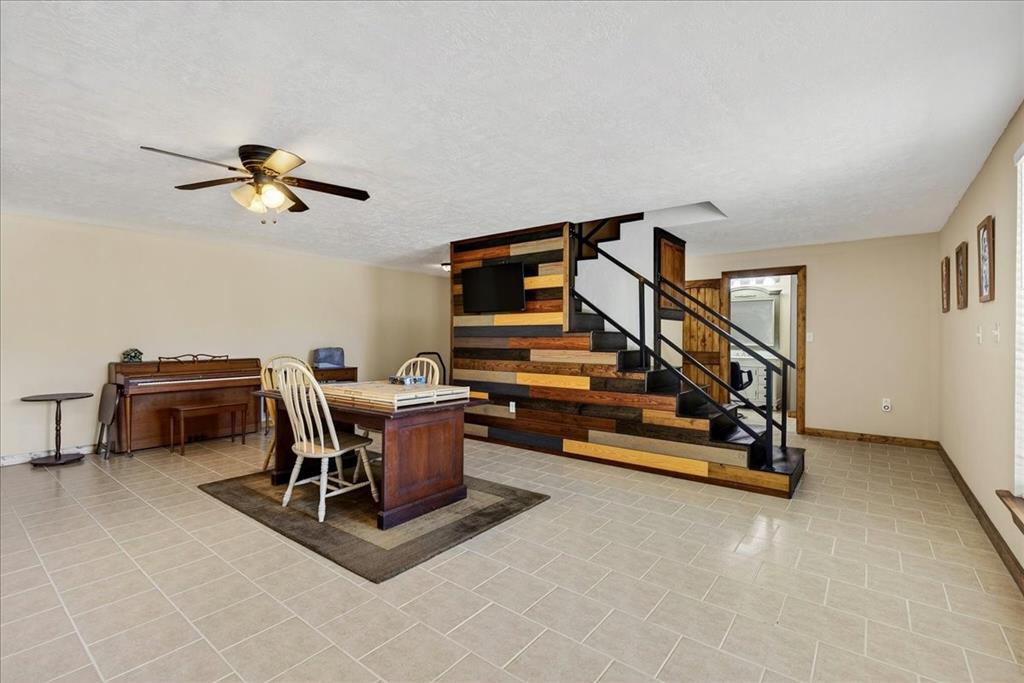 11591 Farm To Market 59 Athens, TX 75751 - Photo 23 of 40 Basement 1565SF Expansive room featuring light-colored square tile flooring. This space has so much potential - Family room, media room, game room, office space, and more. French doors lead outside