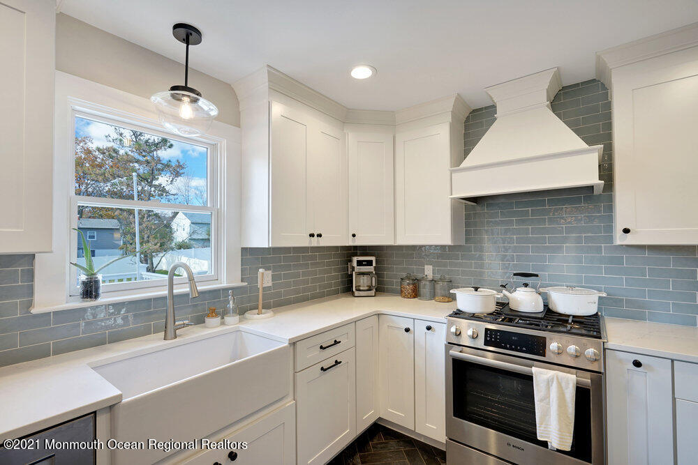 557 Summit Drive Point Pleasant, NJ 08742 - Photo 11 of 41 a kitchen with a sink stove and cabinets