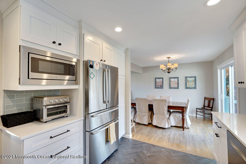 557 Summit Drive Point Pleasant, NJ 08742 - Photo 12 of 41 a kitchen with stainless steel appliances kitchen island granite countertop a refrigerator and microwave