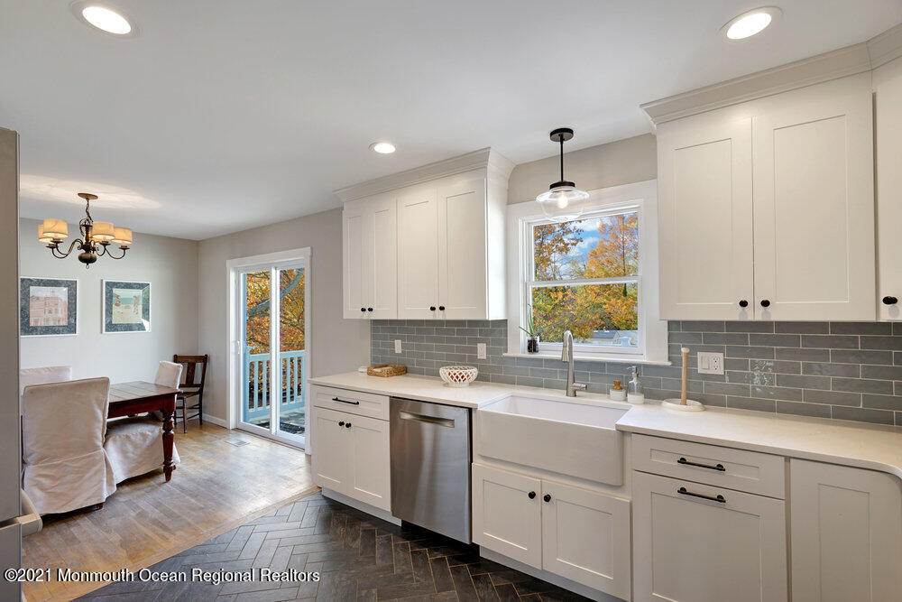 557 Summit Drive Point Pleasant, NJ 08742 - Photo 13 of 41 a kitchen with a sink stove and cabinets