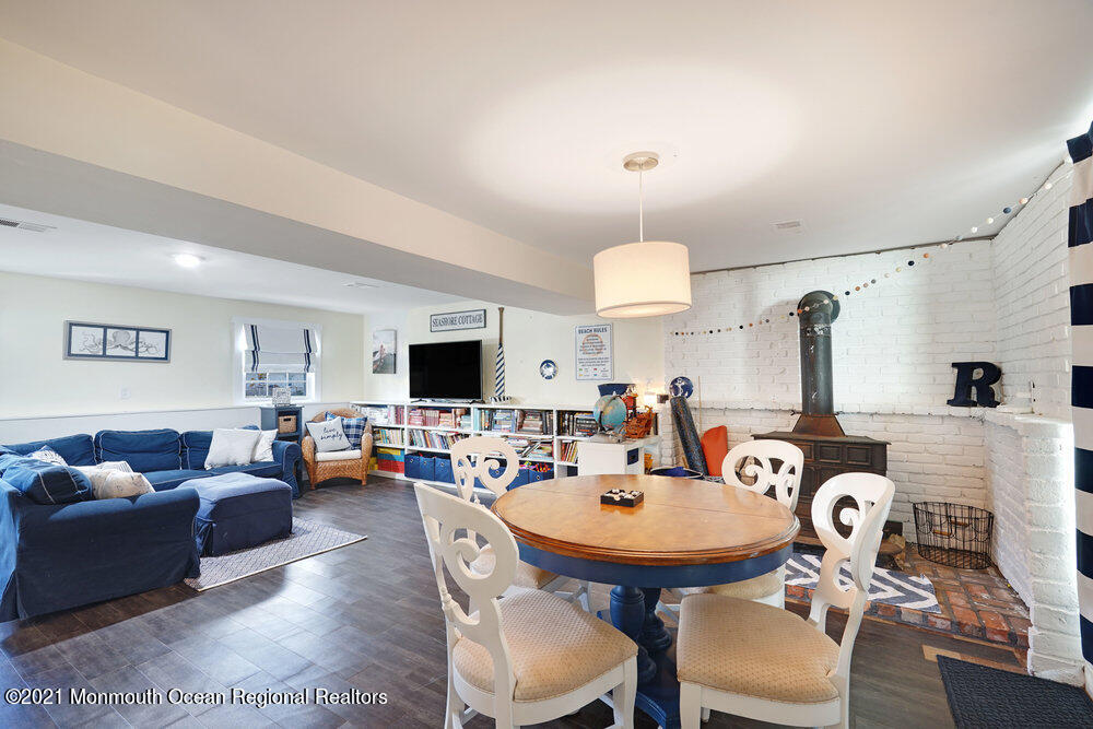 557 Summit Drive Point Pleasant, NJ 08742 - Photo 18 of 41 a living room with furniture a flat screen tv and kitchen view