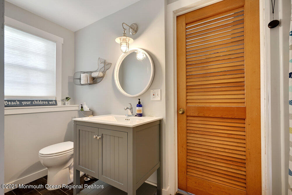 557 Summit Drive Point Pleasant, NJ 08742 - Photo 19 of 41 a bathroom with a toilet a sink and mirror