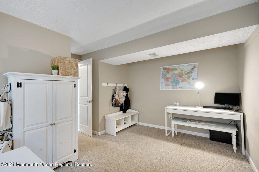 557 Summit Drive Point Pleasant, NJ 08742 - Photo 22 of 41 a room that has a bed and a desk in it