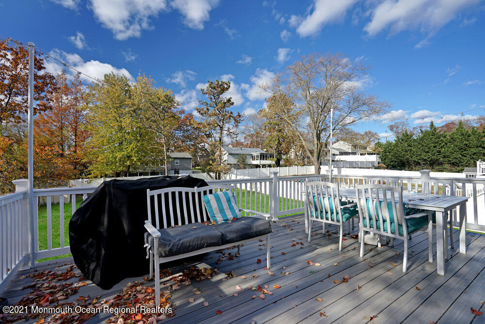 557 Summit Drive Point Pleasant, NJ 08742 - Photo 30 of 41 a view of a deck with a table and chairs with wooden floor and fence