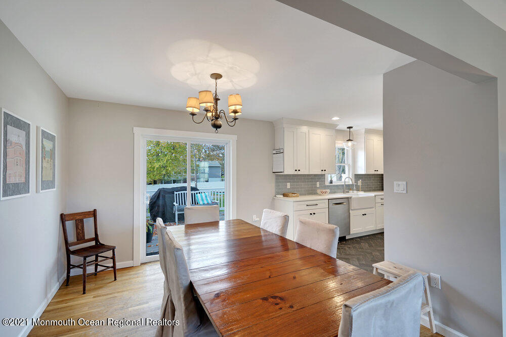 557 Summit Drive Point Pleasant, NJ 08742 - Photo 8 of 41 a large kitchen with kitchen island a chandelier dining table and chairs