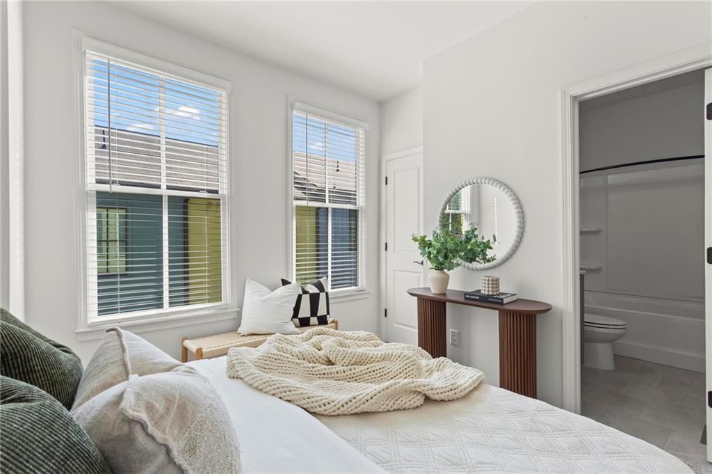 718 Needletail Way Atlanta, GA 30312 - Photo 27 of 44 a bedroom with a bed and a large window