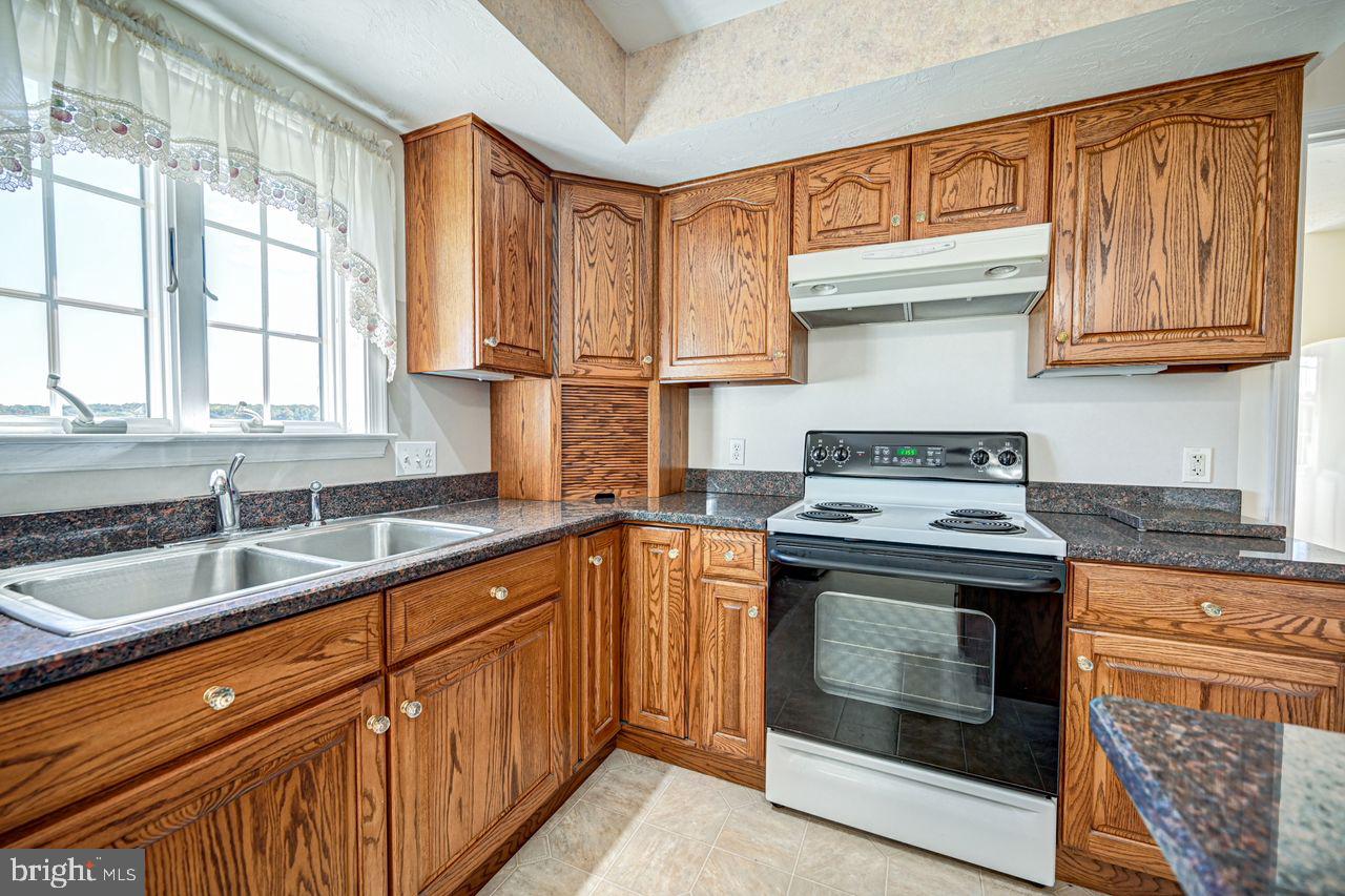 1537 Snyder Corner Road Red Lion, PA 17356 - Photo 16 of 50 a kitchen with stainless steel appliances granite countertop a stove and a sink