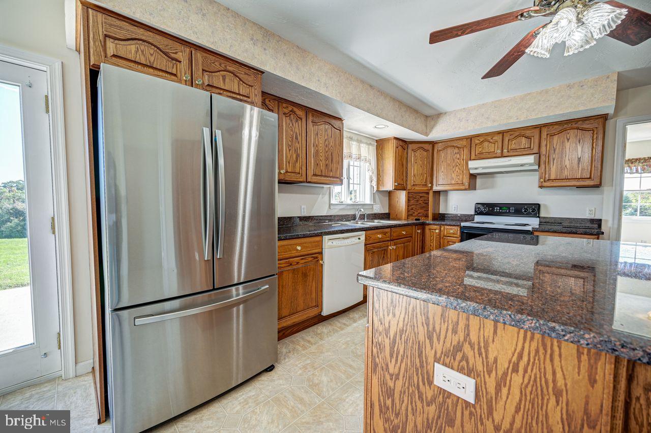 1537 Snyder Corner Road Red Lion, PA 17356 - Photo 17 of 50 a kitchen with stainless steel appliances granite countertop a refrigerator a stove a sink and a microwave