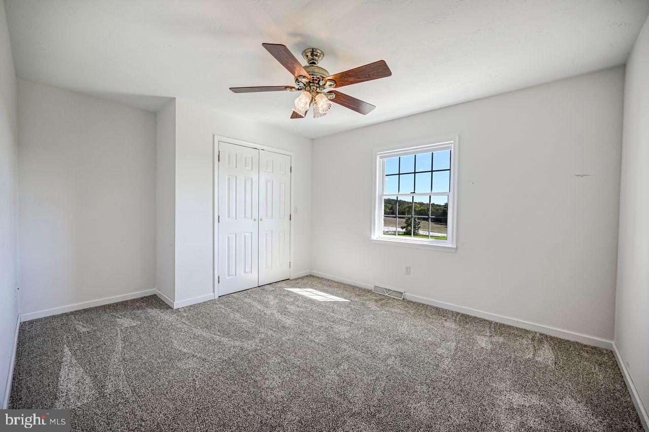 1537 Snyder Corner Road Red Lion, PA 17356 - Photo 24 of 50 a view of a livingroom with a ceiling fan & windows