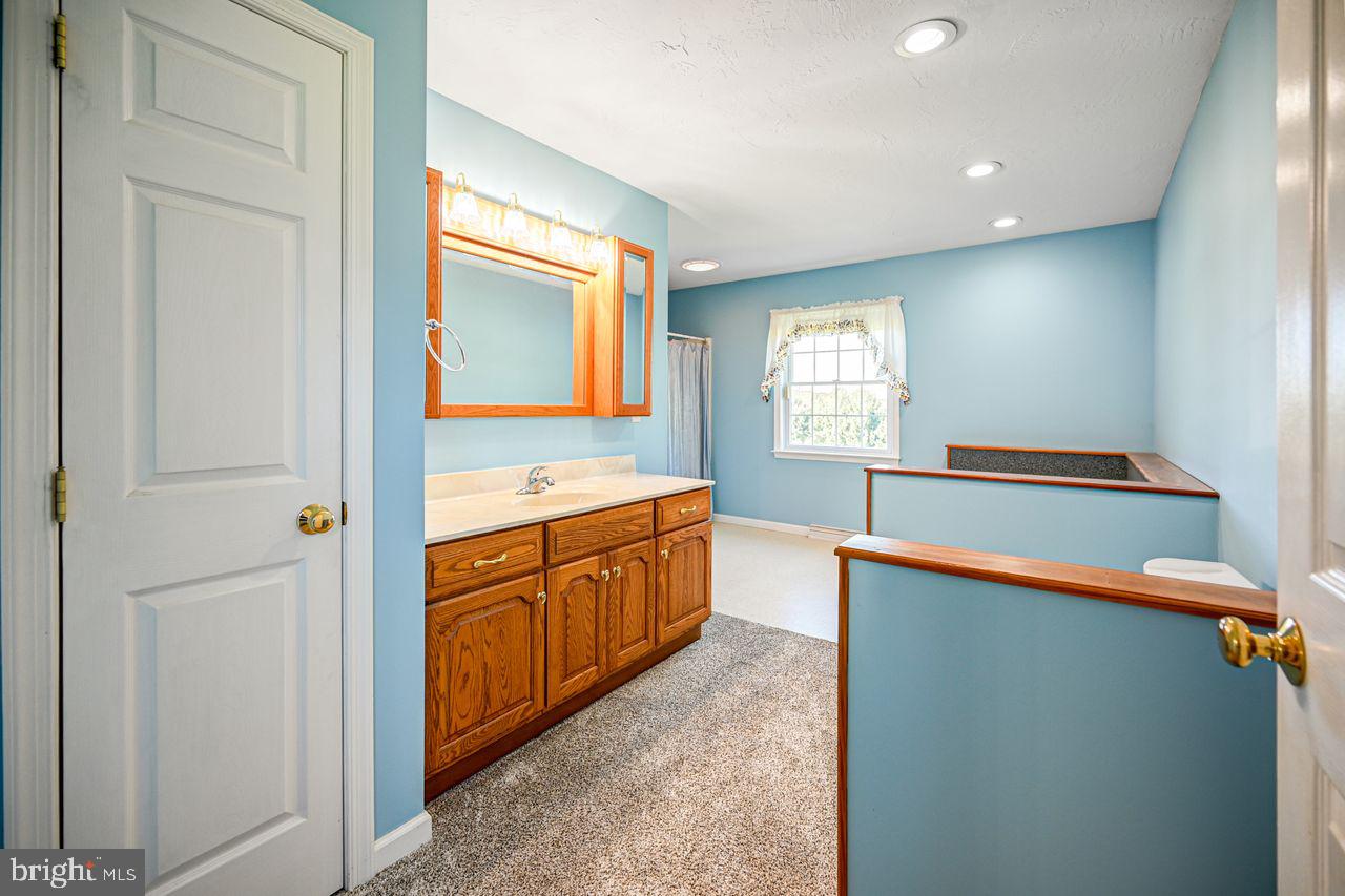 1537 Snyder Corner Road Red Lion, PA 17356 - Photo 28 of 50 a large bathroom with a large mirror vanity and sink