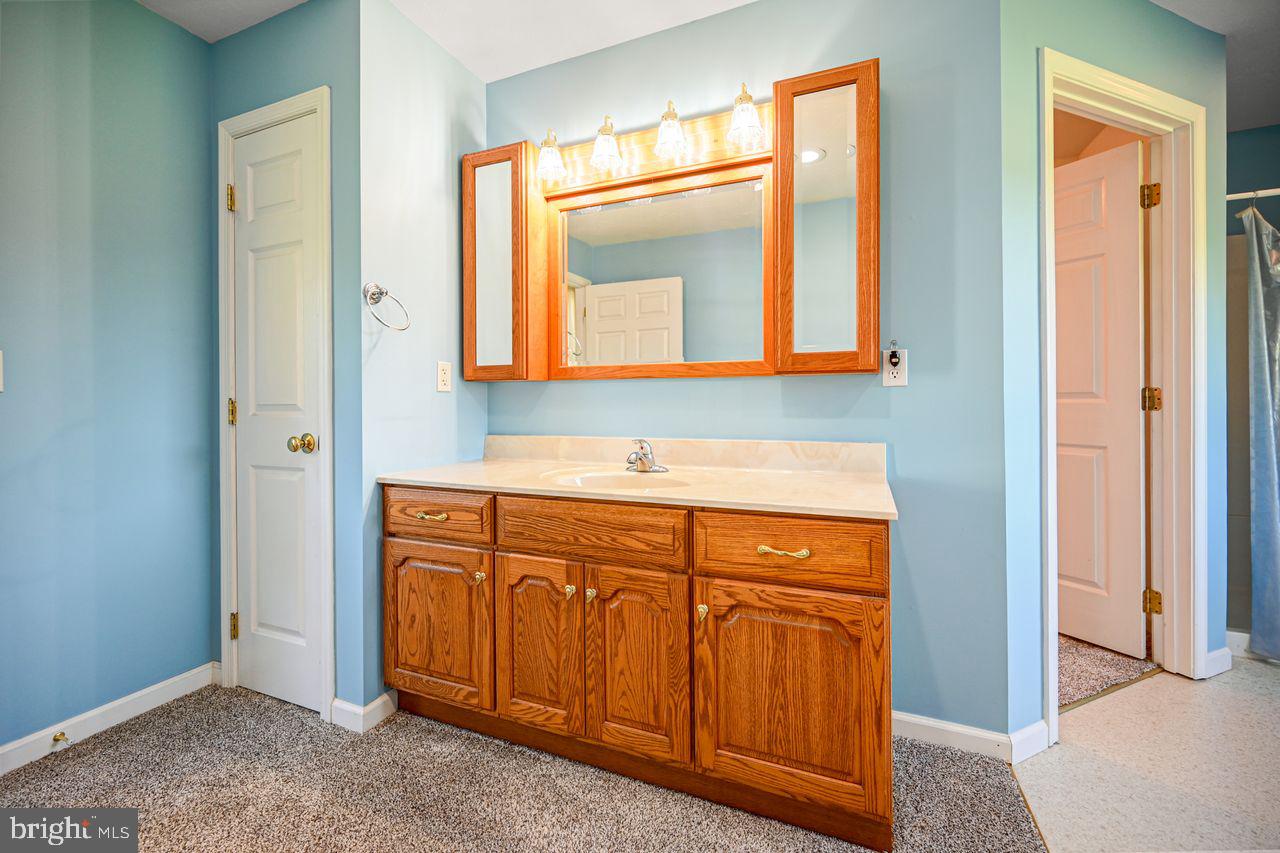 1537 Snyder Corner Road Red Lion, PA 17356 - Photo 32 of 50 a bathroom with a sink and a mirror