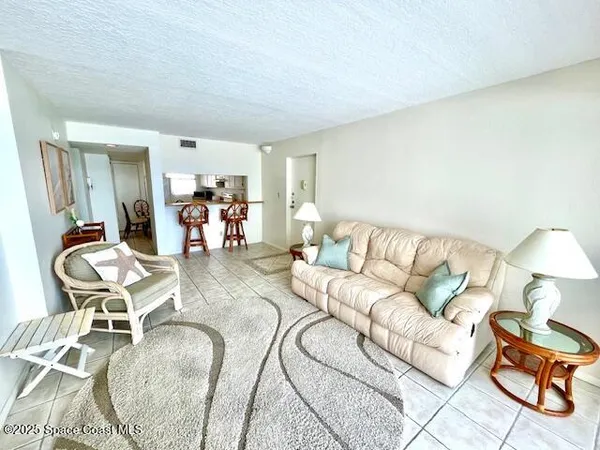 a kitchen with a stove and chairs