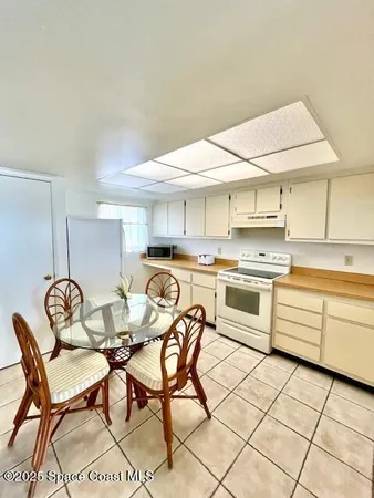a kitchen that has a table and chairs in it
