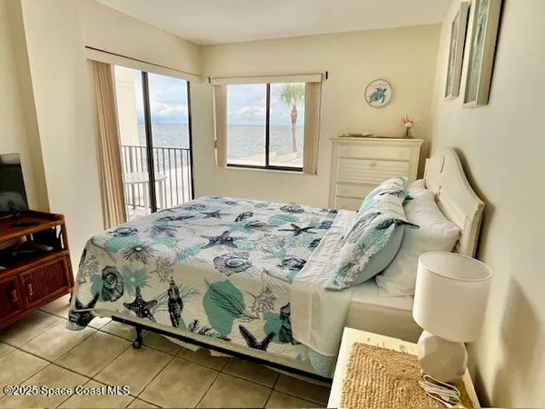 a bedroom with a bed and lamp