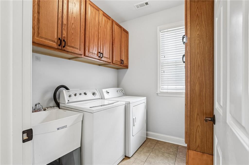 810 Freedom Way Cumming, GA 30040 - Photo 25 of 61 a utility room with dryer and washer
