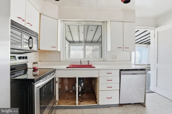 a kitchen with granite countertop a sink and cabinets