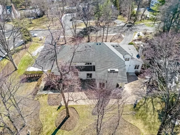 a aerial view of a house with large trees