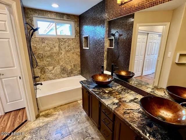 a kitchen with granite countertop a stove and a wooden floor