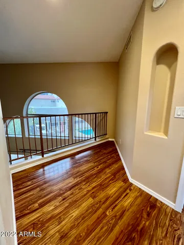 a view of a balcony with wooden floor