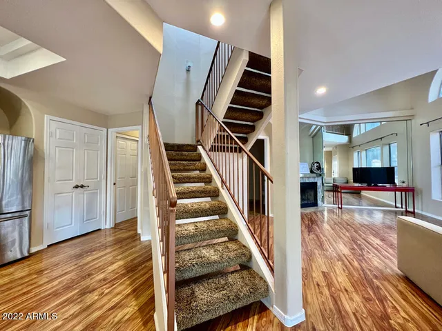 a view of entryway and hall with wooden floor