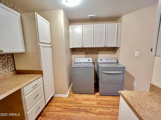 a kitchen with a stove refrigerator and cabinets