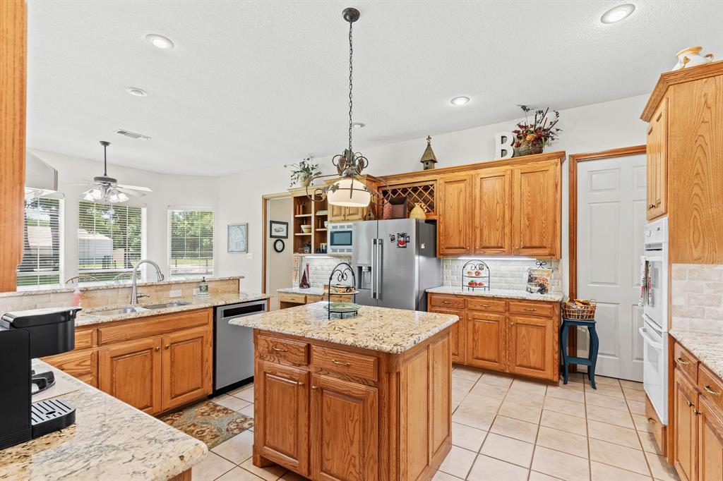 145 Indian Trail Decatur, TX 76234 - Photo 11 of 40 a kitchen with a sink stove and cabinets