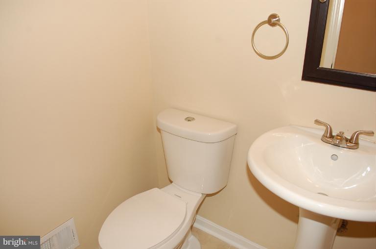 6216 Stevens Forest Road Columbia, MD 21045 - Photo 17 of 30 a white toilet sitting next to a bathroom sink