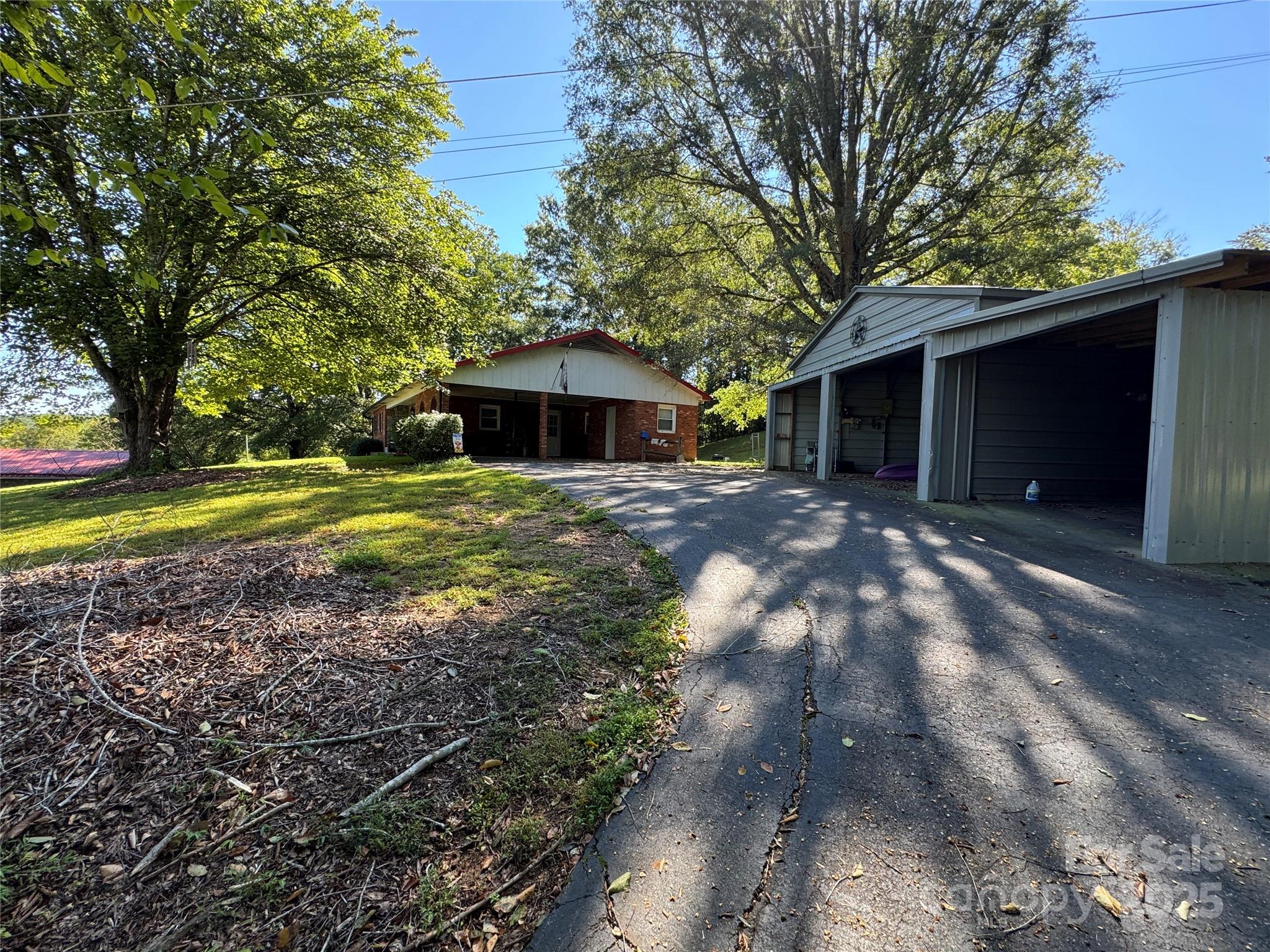 3957 Hollywood Ridge Road Lenoir, NC 28645 - Photo 3 of 20 a front view of a house with a yard and garage