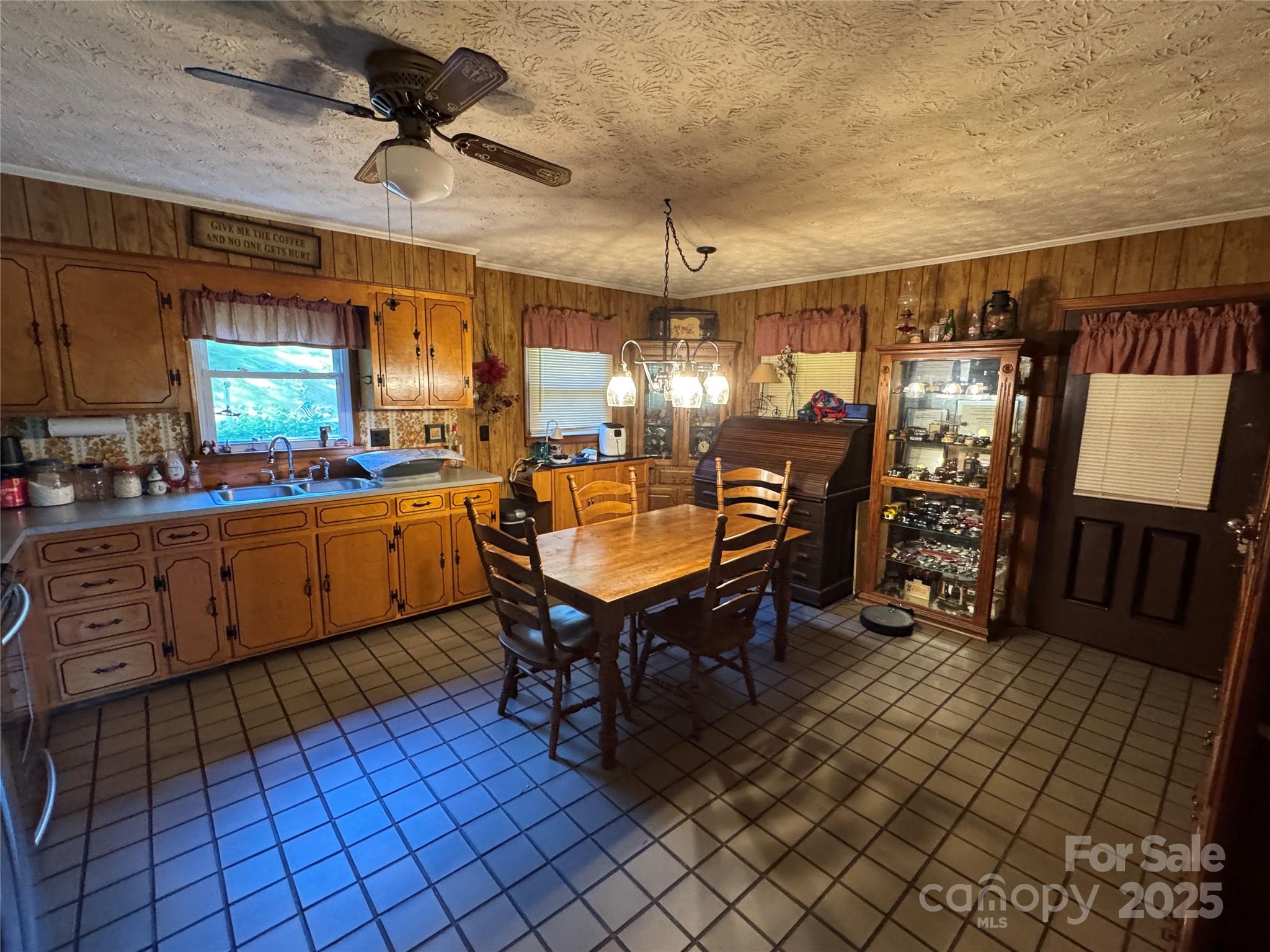 3957 Hollywood Ridge Road Lenoir, NC 28645 - Photo 8 of 20 a room with lots of wooden furniture and a chandelier