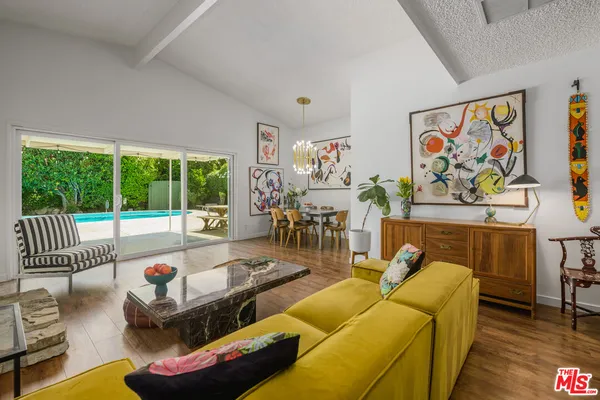 a living room with furniture and a floor to ceiling window
