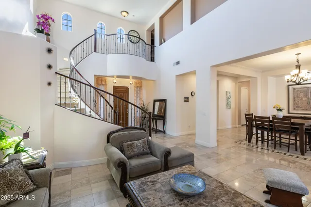a living room with furniture and a dining table with wooden floor