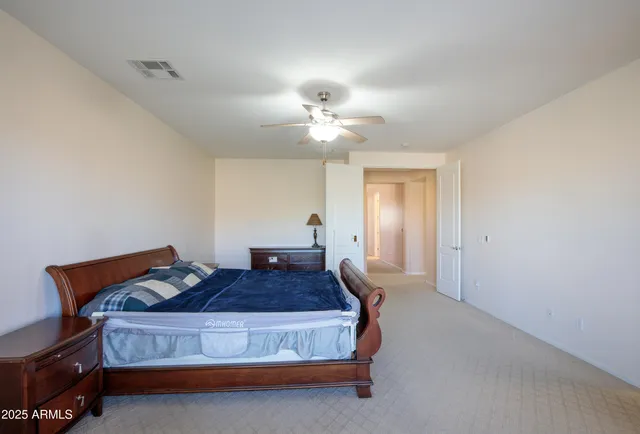 a view of walk in closet with clothes