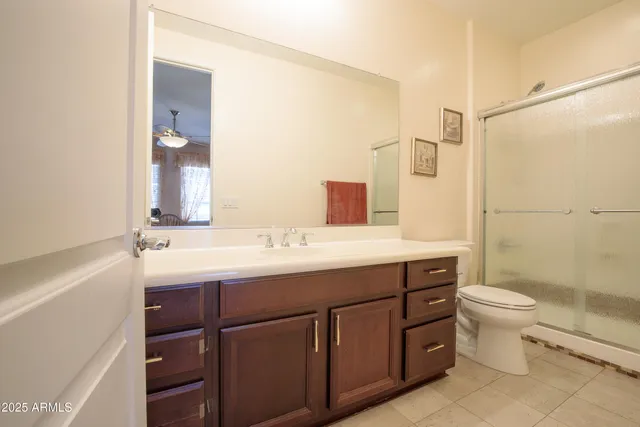 a spacious bedroom with a bed and a chandelier