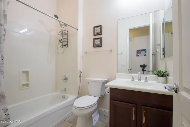 a bathroom with a sink a toilet and shower curtain
