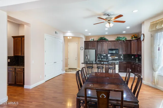 a kitchen with granite countertop a table chairs stove and kitchen view