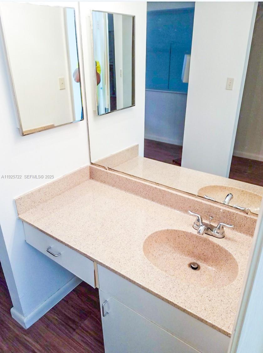 11 Crossings Circle, Unit C Boynton Beach, FL 33435 - Photo 11 of 20 a bathroom with a sink and a mirror