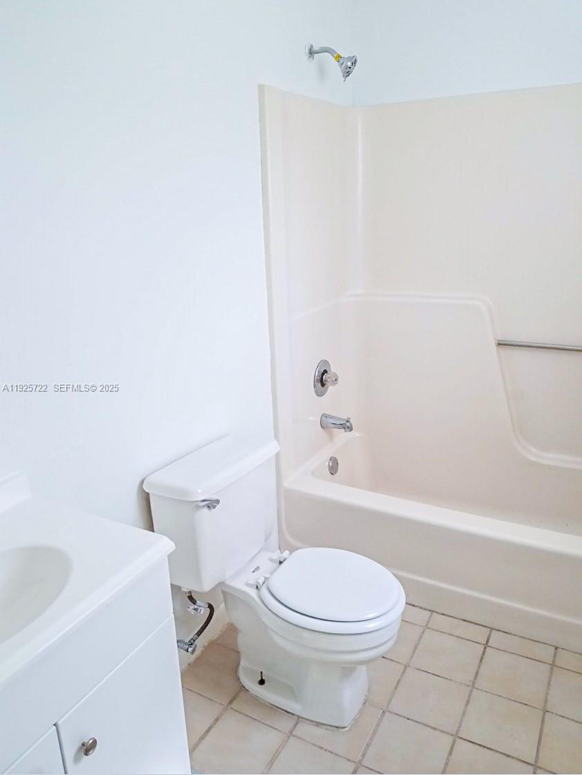 11 Crossings Circle, Unit C Boynton Beach, FL 33435 - Photo 13 of 20 a white toilet and a bath tub sitting in a bathroom